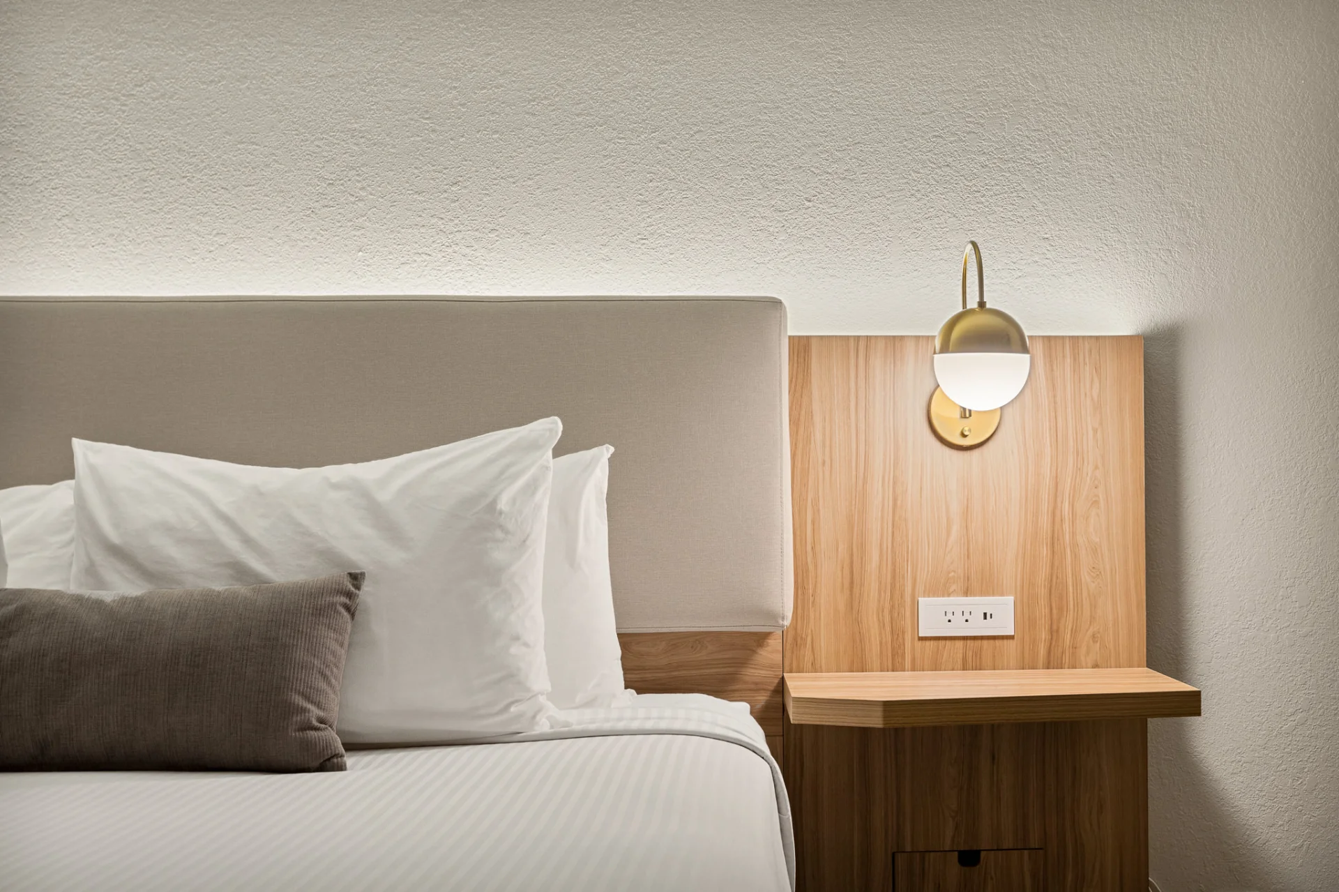 wooden bedside table and lamp